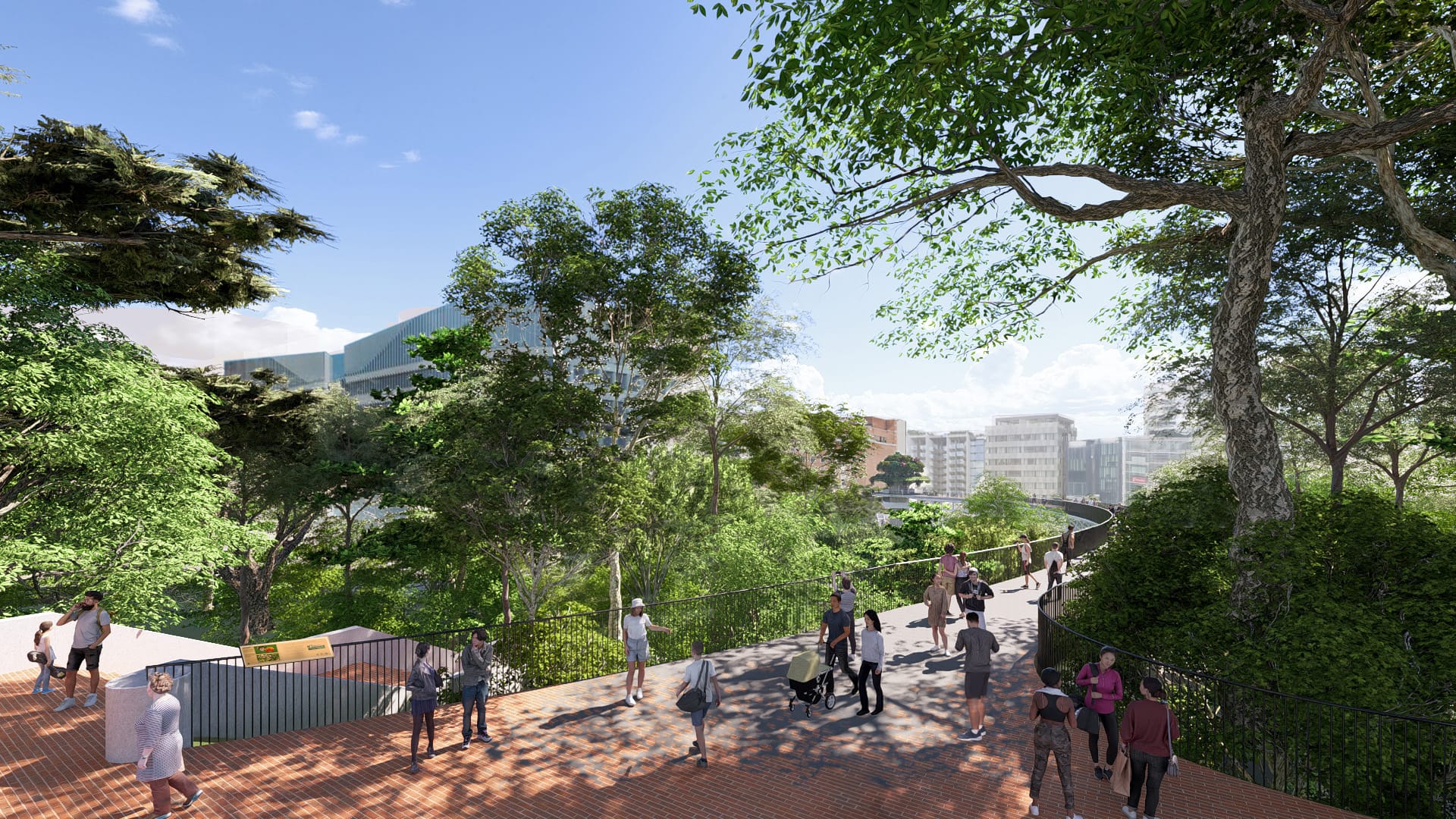People walking on a red brick path lined with trees and greenery. Buildings are visible in the background.